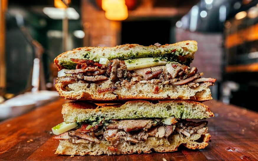 signature porchetta sandwich is a labor of love, prepared out of a deboned whole local pig, rubbed with traditional aromatics: rosemary, fennel, garlic, and black pepper,” chef/owner Michael Toscano said. (Photo/Walker Creative Inc.)