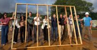 Business leaders from the Greenville community raise the ceremonial first wall for the next home to be constructed under the Habitat Greenville CEO Build program. (Photo/Kelly Mitchell)|Company leaders pledged funding and volunteer hours to help build the 13th CEO Build home for Habitat for Humanity. (Photo/Kelly Mitchell)