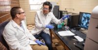 Dong Hou (right) works with Ph.D. student Bryson Hedrick in an Olin Hall lab at Clemson University. (Photo/Clemson University)