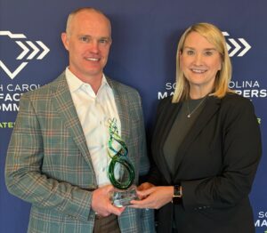 Jake Scott accepts the award from Sara Hazzard, SCMC's president and CEO. (Photo/SCME)