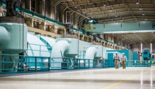 Duke Energy workers walk through the turbine room at Oconee Nuclear Station near Seneca. Environmental groups and Duke Energy reached a settlement tied to the utility’s proposal to merge its Carolinas and Progress subsidiaries. (Photo/Duke Energy)