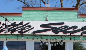 The owners of Little Secret went in for a little whimsy — in their sign, their décor and their menu. (Photo/Stephanie Kalina-Metzger)