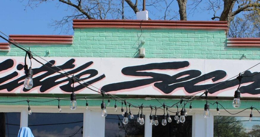 The owners of Little Secret went in for a little whimsy — in their sign, their décor and their menu. (Photo/Stephanie Kalina-Metzger)