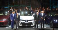 Milan Nedeljković, chairman of the Board of Management, BMW AG; Sen. Lindsey Graham, Gov. Henry McMaster and Robert Engelhorn, president and CEO of BMW Manufacturing Co., join the men and women who assemble the automobiles for the new BMW X5 debut. (Photo/Ross Norton)