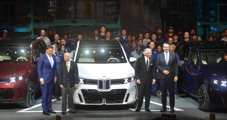 Milan Nedeljković, chairman of the Board of Management, BMW AG; Sen. Lindsey Graham, Gov. Henry McMaster and Robert Engelhorn, president and CEO of BMW Manufacturing Co., join the men and women who assemble the automobiles for the new BMW X5 debut. (Photo/Ross Norton)